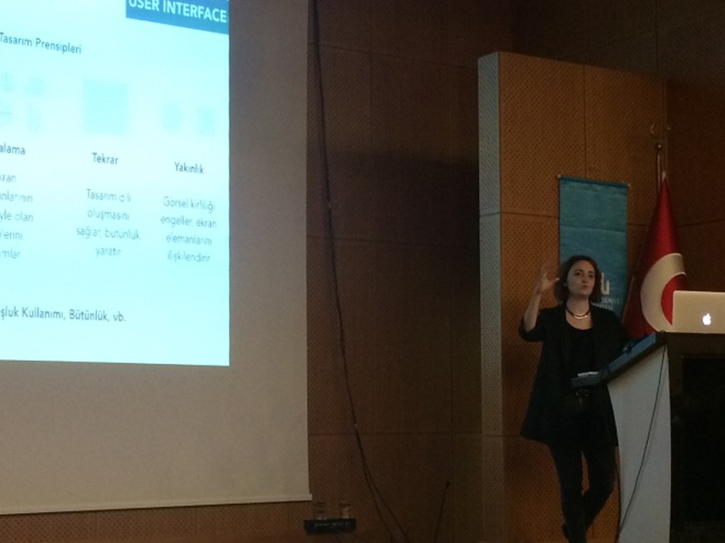 Deniz speaking at a university event
